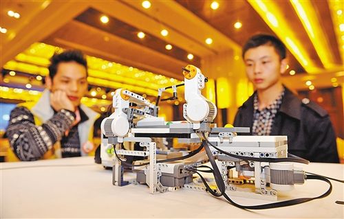 12月5日,重庆机器人综合城项目战略合作签约仪式在渝举行。图为市民正在观看益乐机器人现场表演。 记者 梅垠 摄
